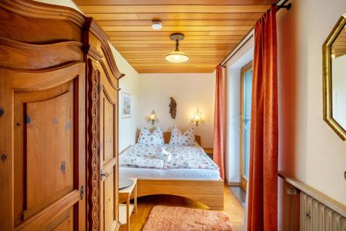 a bedroom with a bed and a wooden ceiling at Ferienwohnung 3 in Grassau