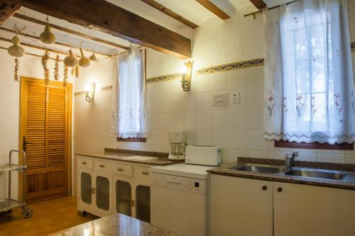 a kitchen with a sink and a counter top at Can Murenu in Sant Joan de Labritja