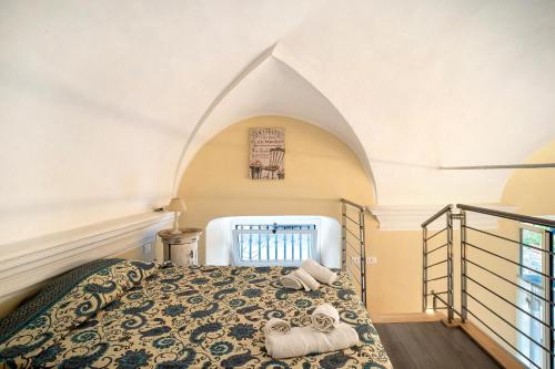 a bedroom with a bed with towels on it at Conchiglia, borgo dei pescatori in Cervo
