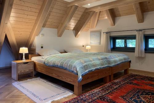 a bedroom with a large bed with wooden ceilings at Familienhaus in Trebel