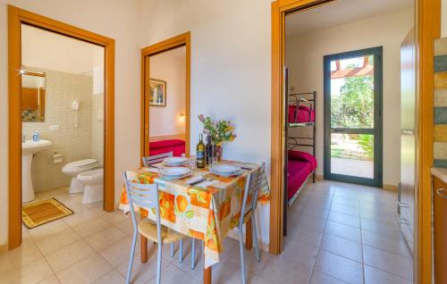 a dining room with a table and a bathroom at Lilybeo Village - Camping & Residence in Marsala