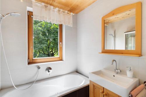 a bathroom with a sink and a window at Silbernagl - Monolokal mit Ausblick in Issengo