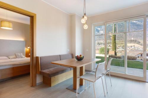 a dining room with a table and chairs and a window at Landhaus Antonius Eppan in Appiano sulla Strada del Vino