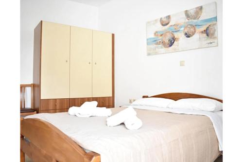 a bedroom with two beds with towels on them at Manolika Studio 4 in Kithnos