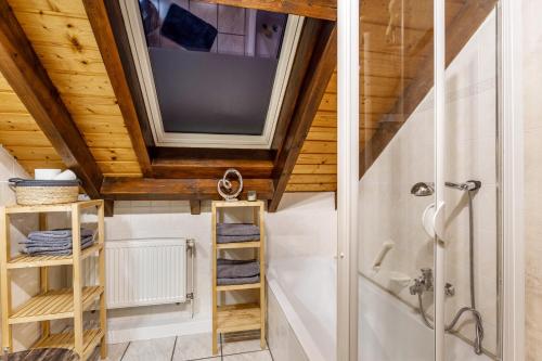 a bathroom with a shower and a tv on the ceiling at Ferienwohnung Rinke in Schmallenberg