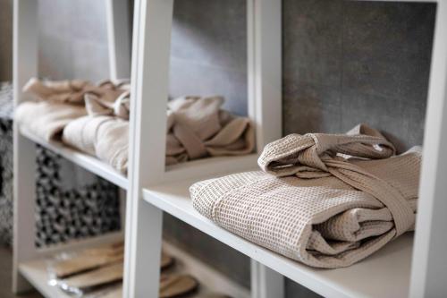 a white closet with towels on the shelves at Residence soleluna - Loft Sirio in Roisan