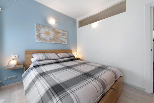 a bedroom with a bed with a striped bedspread at Il Gelsomino in Castro