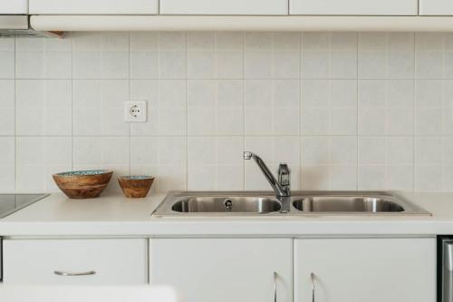 a kitchen sink with two bowls on a counter at Bella Vista Vacation House in Serifos Chora