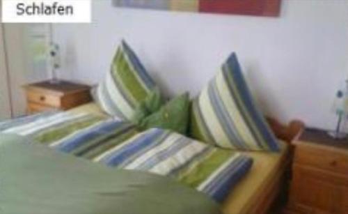 a bed with two pillows on it in a bedroom at Haus Schnitzler in Wasserburg