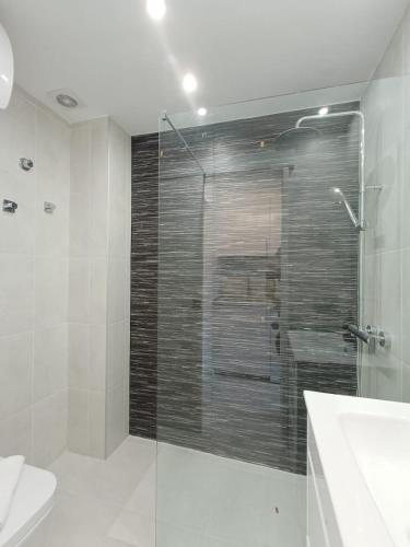 a bathroom with a shower and a toilet and a sink at Torres in Antigua