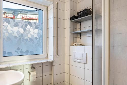 a bathroom with a sink and a window at Ferienwohnung Tannenblick 1-3 in Oberhof