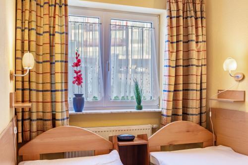 a bedroom with two beds and a window at Ferienwohnung Tannenblick 1-3 in Oberhof