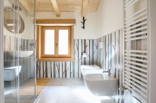a bathroom with two sinks and a glass shower at Bellagio - Baita treeb Breva in Bellagio