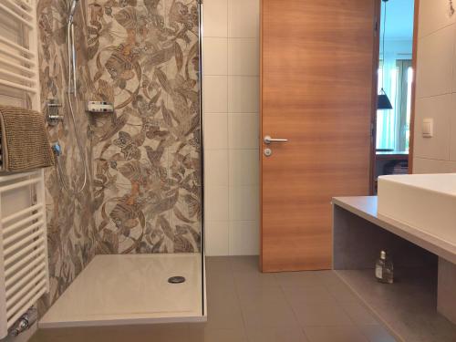 a shower with a glass door in a bathroom at Apartment Matthäus in Cermes