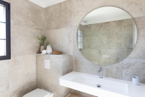 a bathroom with a sink and a mirror at Villa Catherine in Ghisonaccia