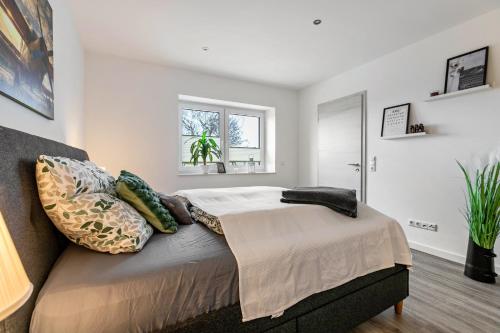 a bedroom with a bed with pillows on it at Mika in Oesterdeichstrich