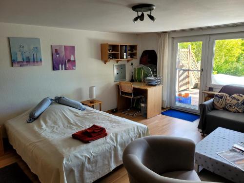a bedroom with a bed and a desk and a chair at Ferienwohnung Brixius in Koblenz