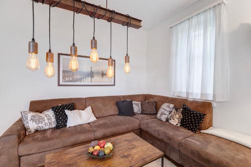 a living room with a brown couch and a table at Rotes Haus über den Weinbergen in Konstanz