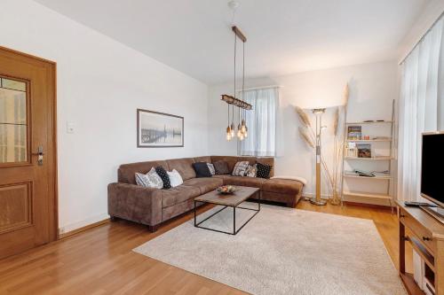 a living room with a couch and a tv at Rotes Haus über den Weinbergen in Konstanz