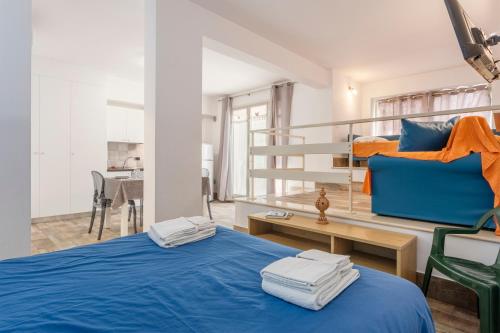a bedroom with a blue bed and a bunk bed at Casavacanzefranca - 12 in Terrasini