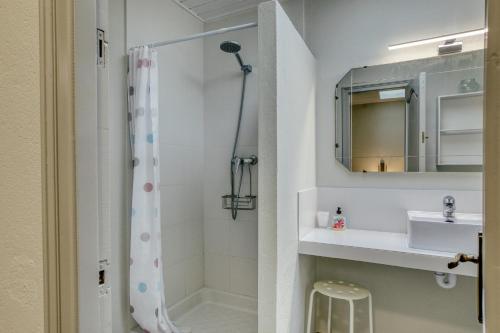 a bathroom with a shower and a sink and a mirror at Casa adosada in Begur