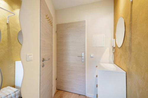 a bathroom with a door and a sink at Mini Apartment in Bayreuth