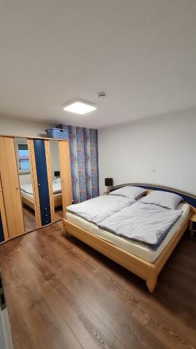 a bedroom with a bed in a room at Ferienwohnung Helfensteinblick in Calden