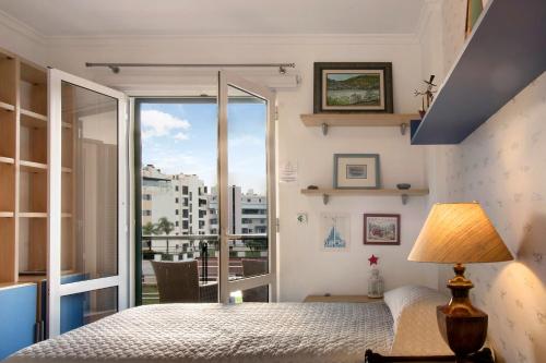 a bedroom with a bed and a large window at Seaside Escape in Funchal