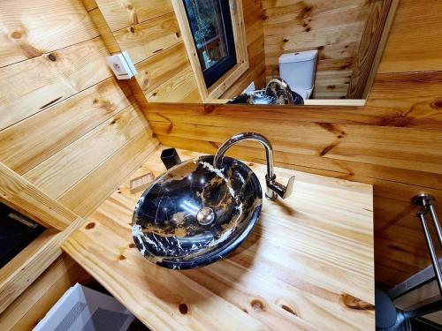 an overhead view of a bathroom sink in a tiny house at Le Chalet Aura et Jacuzzi in Abreschviller