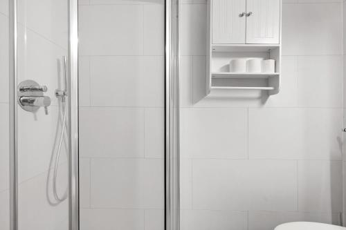 a bathroom with a shower stall and a toilet at Marilleva 900 Kristall in Mezzana