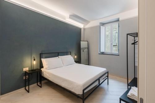 a bedroom with a large white bed and a window at Dimora Borgo Antico Lucia in Ascea