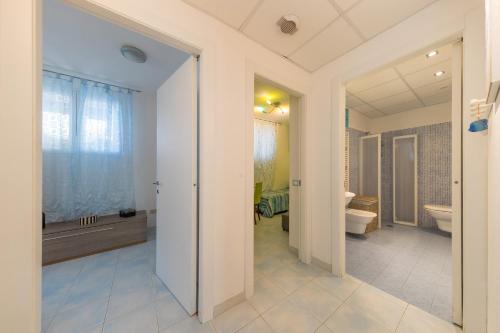 a bathroom with a tub and a toilet and a sink at Castiglioncello Mare Apartment in Castiglioncello
