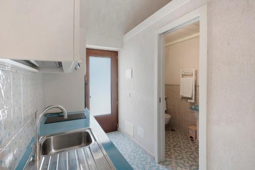 a bathroom with a sink and a toilet at Dimora elegante in Costa d'Amalfi in Conca dei Marini