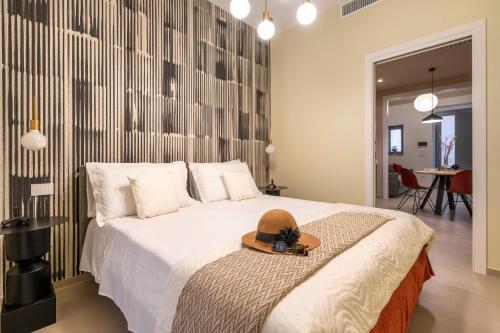 a bedroom with a bed with a hat on it at Dimora Màufra in Locorotondo