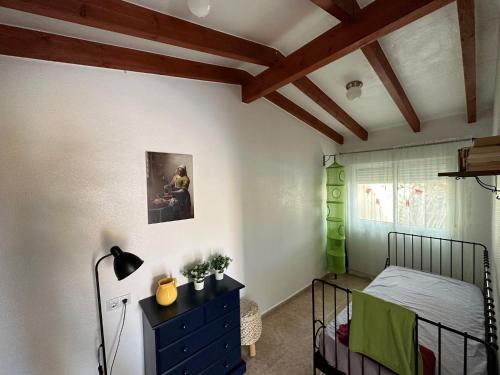 a bedroom with a black bed and a black dresser at Villa Miantojo in Mazarrón