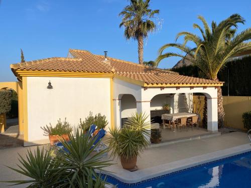 a villa with a swimming pool and a house at Villa Miantojo in Mazarrón