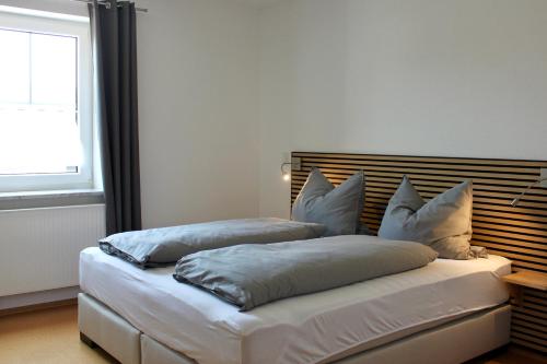 two beds with pillows on them in a room at Fewo Feldblick in Merkendorf