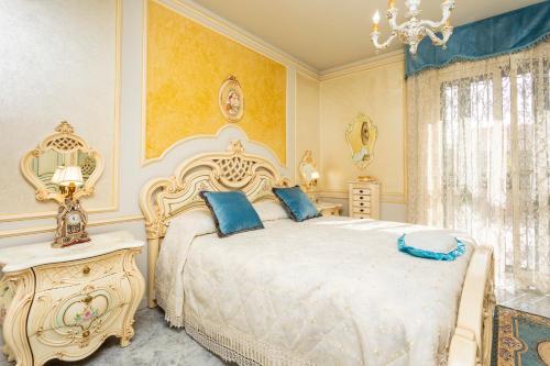 a bedroom with a white bed with blue pillows at Villetta Mare e Monti in Mascali