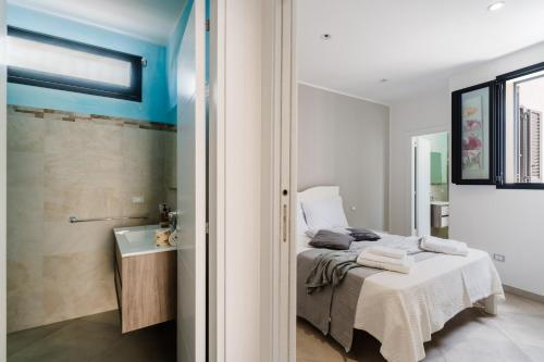 a bedroom with a bed and a bathroom with a sink at Casa Vacanza Susanna in Otranto