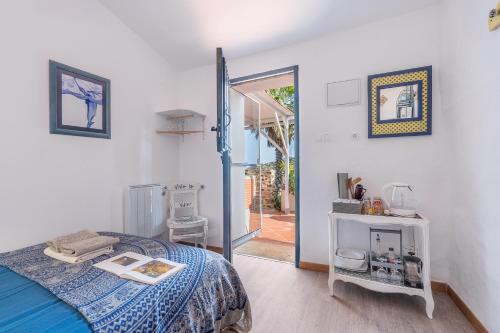a bedroom with a bed and a sliding glass door at Cortijo La Alamea in Almuñécar