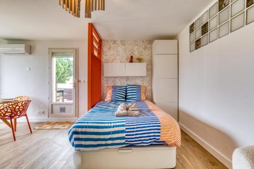 a bedroom with a bed with two stuffed animals on it at Sunny Day in La Grande Motte