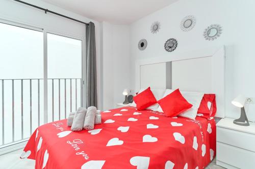 a bedroom with a red and white bed with red pillows at Nerja Boutique 204 Beauty in Nerja