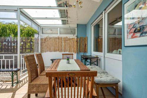 a dining room with a table and chairs on a patio at Casa Noho in Nonnenhorn