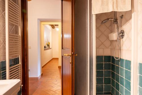 a bathroom with a shower and a toilet and a sink at Apartament Monastero in Cortona