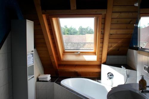 a bathroom with a sink and a window at Fewo Feldblick in Merkendorf