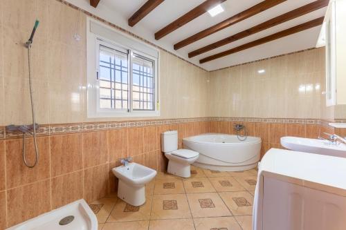 a bathroom with a tub and a toilet and a sink at La Tierra in Níjar