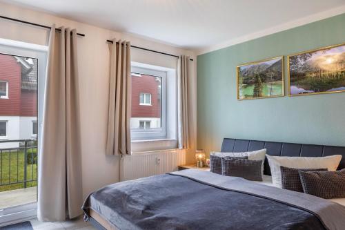 a bedroom with a bed and a large window at Ferienwohnung Tannenblick 2-1 in Oberhof