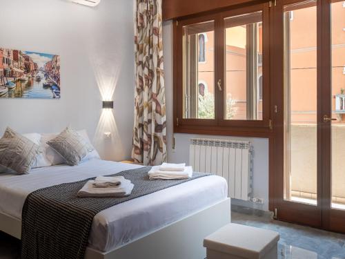 a bedroom with a bed with two towels on it at Casa Bella Venezia 1 in Mestre