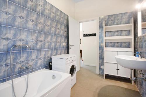 a bathroom with a washing machine and a sink at Villa Del Sole in Bonassola
