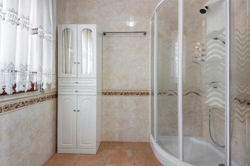 a bathroom with a shower and a glass shower backdoor at Casa Cimo D'Aldeia in Vila Cova de Perrinho